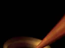 A 3-D printer “draws” a coiled antenna in the air. What allows the printer to work this way is a laser that hardens an “ink” of silver nanoparticles as they emerge from the nozzle.