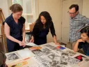 Hinton arranges materials for the Angela Davis exhibit with (from left) Radcliffe arts program manager Meg Rotzel, gallery coordinator Joe Zane, and Pforzheimer fellow Jackie Wang.