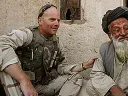 Photograph of Kit Parker on duty in Afghanistan, spring 2003, with a village leader in Kandahar Province
