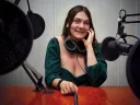 Juna Gjata with a microphone in front of her