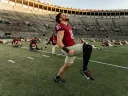 Harvard football players limbering up for season-opening game
