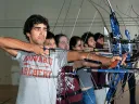 Samuel Saidel-Goley (foreground) and Archery Club colleagues draw their bows.