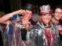 Students from the Harvard Business School (HBS) party on despite the rain. The HBS contingent in the parade carried replicas of the centennial bell from that school's 2008 anniversary.