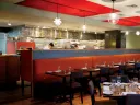 Evoo’s earthy food is served in a modern, open interior with a view of the kitchen.