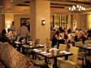 Ambient lighting and comfy chairs star in the second-floor dining room. 