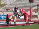 Crimson quarterback Michael Pruneau was almost trapped for a safety by Cornell linebacker Tre’ Minor in the final quarter at Schoellkopf Field. Pruneau escaped, and directed a late drive that gave Harvard a 34-24 victory over the Big Red. At right is tailback Paul Stanton Jr., the game’s top ground-gainer.