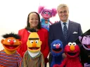 Harvard education dean Bridget Terry Long and Sesame Workshop CEO Jeffrey Dunn with a group of Muppets