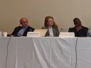 Photo of three speakers seated at a table