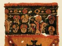 A colorful Byzantine funerary tunic fragment depicts faces and vegetal patterns with a border of gemstones.