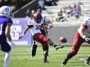The Harvard punter kicks the football
