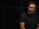 Reginald Dwayne Betts seated in front of a black background