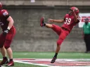 Jon Sot punts a football.