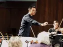 Sam Wu conducts an orchestra