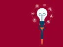 A person holding a light bulb with icons representing innovation and ideas surrounding it.