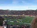 A large group of protestors standing on a football field.