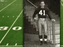 Carroll Lowenstein standing at the base of staircase