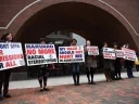 Photograph of demonstrators in front of the federal courthouse in Boston where the SFFA v. Harvard trial took place, with signs reading "Harvard No More Racial Stereotyping" and "My Race Should Not Hurt Me In Admissions.