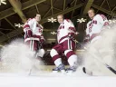 Hard-skating brothers Danny, Alex, and Michael Biega (left to right) spray ice chips at Bright Hockey Center.