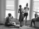 While being evicted from her Milwaukee apartment, Danielle Shaw (left) and relatives wait until the movers carrying down her refrigerator and stove are no longer blocking the stairwell. 
