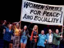 Scene from "Gloria, A Life," showing women marching in solidarity with protest sign