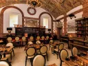Cozy Map Room Tea Lounge with books, bar, and vaulted ceiling