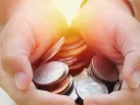 Hands holding coins