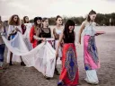 A procession of women heading toward a lake