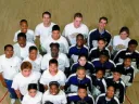 StreetSquash (left) and SquashBusters teams with mentors Polsky and Zaff (back row, second and fourth from left).