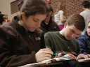 Sophomore Meryl Federman and senior Adam N. Hallowell keep themselves busy during a break in the action at Brown University&rsquo;s early fall tournament.